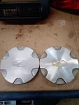 1998 Oldsmobile Bravada Two Wheel Rim Center Caps For 15" Aluminum. Fixed Price $48.00.