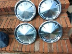 Set Of Four Plymouth 1959 Pointed Center Wheel Covers. Fixed Price $90.00.