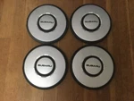 Set Of 4, 1985-90 Subaru Center Caps. #68663. Fixed Price $50.00.
